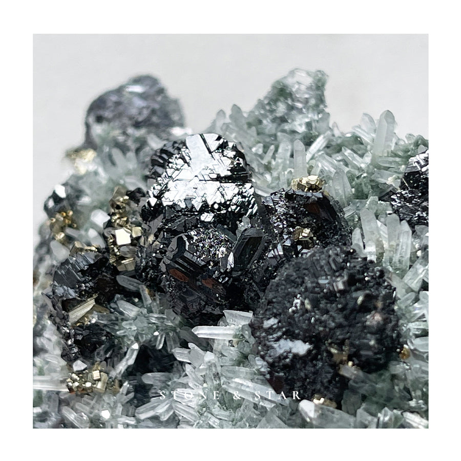 Tetrahedrite, Pyrite and Chlorite included Needle Quartz on a bed of Iridescent Mirror Galena